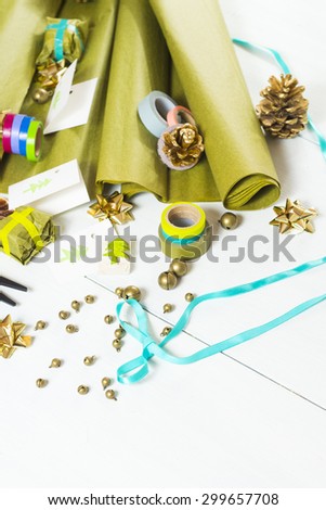christmas gift packaging with green papers and cards with christmas tree print