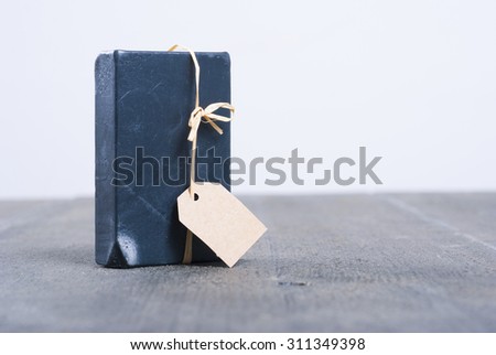 carbon soap with empty gift card on dark wooden table