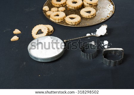 cookies on baking tin, on black cloth