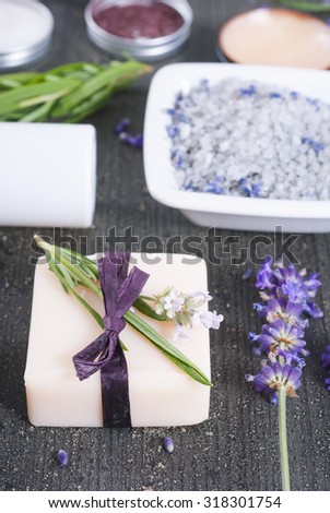 bath salt, soap  with fresh lavender flowers on black wooden texture