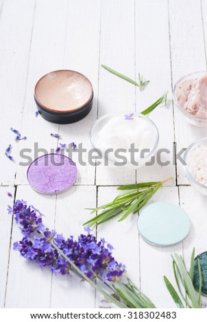 grooming products and fresh lavender bouquet on white wooden table background