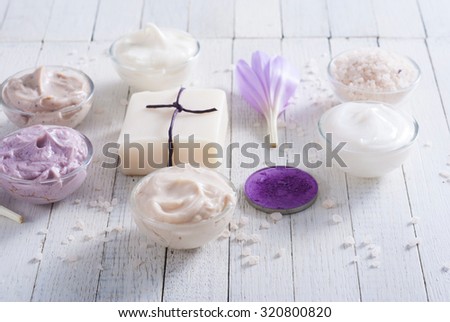 cosmetic cream variations, soap and bath salt with autumn crocus herbal flower on white wooden table