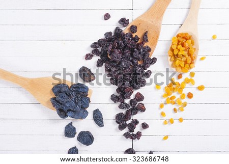 dried  cherry, raisin and plum fruits on white wood