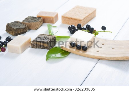 salt and milk soaps, hair colorant henna blocks on white wooden table