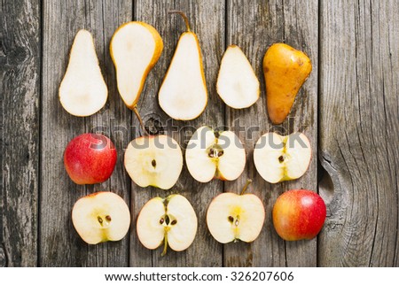 sliced apples and pears on old wood table