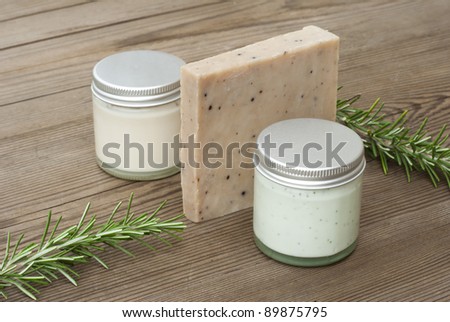 handmade soap, natural cream and rosemary on wooden