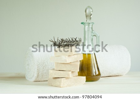 natural soaps, towel, and cosmetic oil on wooden