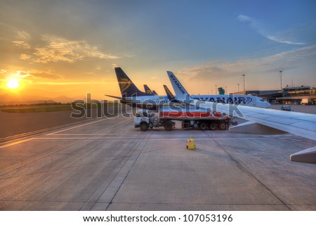 BERGAMO - JUNE 06:Ryanair airplanes on the parking and beautiful sunrise on background at Orio al Serio International Airport.Ryanair is world leader low cost company in Bergamo,Italy on June 06,2012.