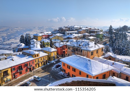 Aerial view on small town, houses and roofs covered with snow at Diano D\'Alba in Piedmont, Northern Italy.