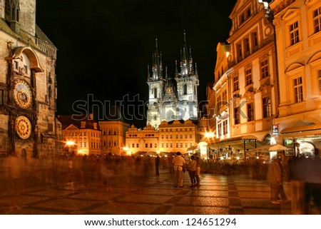 PRAGUE - JULY 05: Old Town Square with people, illuminated buildings and Tyn Church on background at evening. The square is very popular with tourists  in Prague, Czech Republic on July 05, 2004.