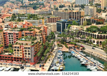 Small marina with yachts and boats among modern buildings in Monte Carlo, Monaco (view from above).