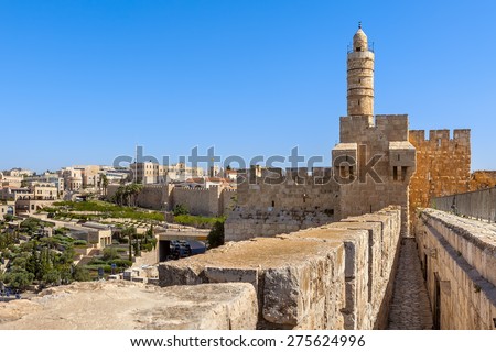 Tower of David and ancient citadel under blue sky as Mamilla neighborhood on background in Jerusalem, Israel.
