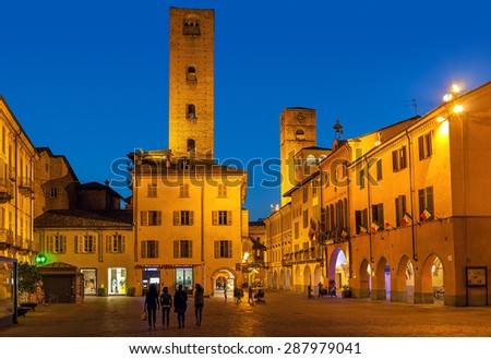 ALBA, ITALY - MAY 06, 2015: View on small plaza among old houses and medieval towers in Alba - capital of Langhe area, famous for its white truffle, peach and wine production.