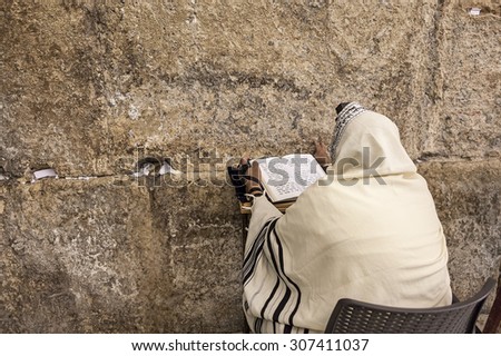 JERUSALEM, ISRAEL - JULY 16, 2015: Prayer prayes at Western Wall on Tisha B\'Av - annual fast day in Judaism, commemorates anniversary of destruction of the First and Second Temples in Jerusalem.