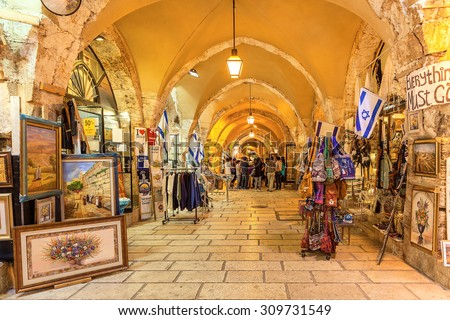JERUSALEM, ISRAEL - JULY 16, 2015: Gift shops inside of stone vault passage in Old City of Jerusalem - one of the oldest cities in the world and holy in Judaism, Islam and Christianity.