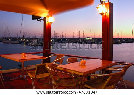 Outdoor restaurant on marina at Mediterranean sea at evening in Ashqelon, Israel.