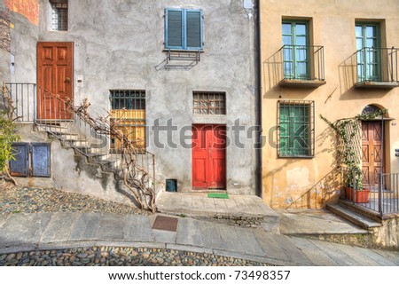 Wooden multicolored doors in the old house at the town of Saluzzo, northern Italy.