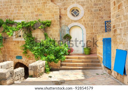Small courtyard and stoned house with white door in old part of Jaffa (Yafo), Israel.