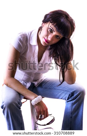 Portrait of beautiful young brunette woman in casual clothes on bar chair