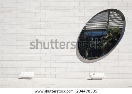 LISBON, PORTUGAL - JULY 13: two benches and an oval window in  Champalimaud Centre for the Unknown designed by Charles Correa on July 13, 2014.