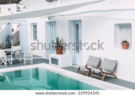 OIA, SANTORINI, GREECE - NOVEMBER 3: seats near the pool in Caldera Villas, one of the hotels located in Oia, Santorini, Greece on November 3, 2014.