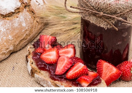 Bread with Strawberry Jam on rustic background
