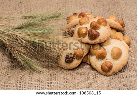 Cookies with nuts on top on rustic background