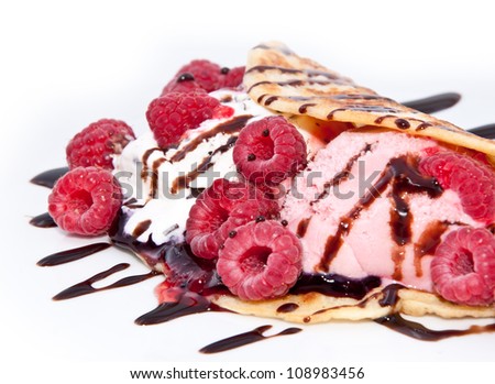 Fresh Raspberry ice cream in a Pan Cake decorated with Raspberries and chocolate syrup