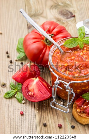 Fresh made Bruschetta Sauce in a glass on wooden background