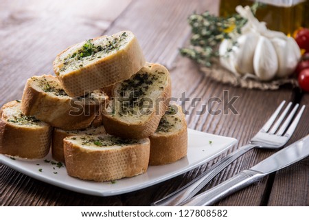 Some Garlic Bread pieces on wooden background