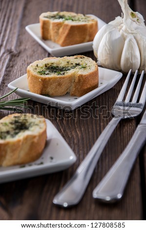 Portion of Garlic Bread on wooden background
