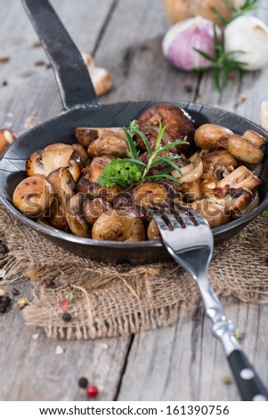 Mushrooms in a vintage Pan with fresh herbs