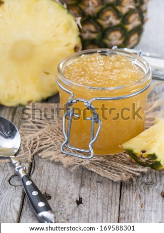 Homemade Pineapple Jam in a small glass with fresh fruit pieces
