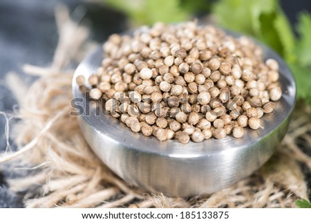 Small bowl with fresh Coriander Seeds (close-up shot)