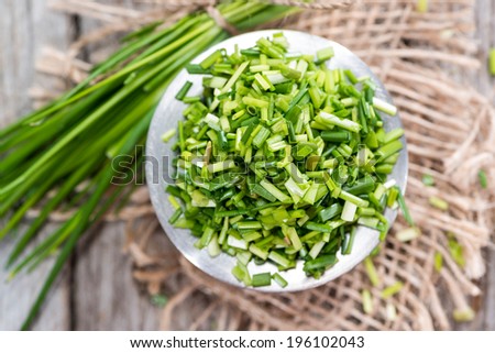 Small portion of fresh cutted Chive on vintage background