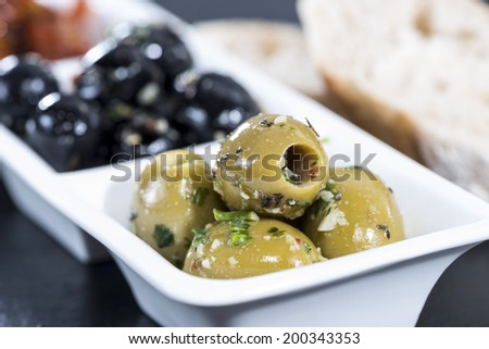 Mixed Olives (black and green ones) marinated with garlic and fresh Mediterranean herbs
