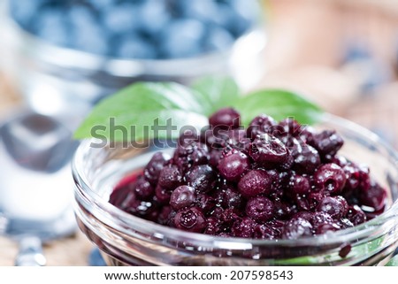 Portion of canned Blueberries with some fresh fruits