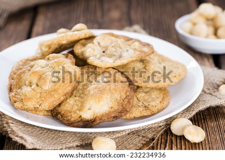 Homemade Cookies with Macadamia nuts (on wooden background)
