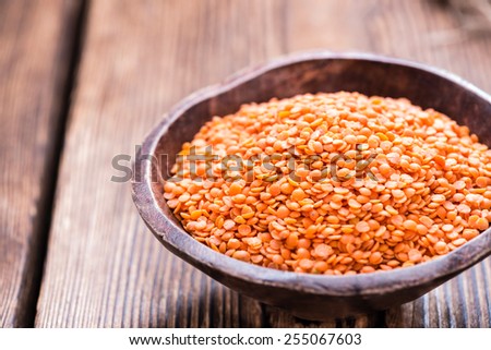 Heap of Red Lentils (close-up shot) on rustic background