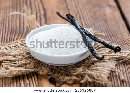 Portion of white Vanilla Sugar (detailed close-up shot) on wooden background