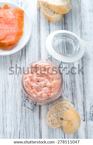 Creamy homemade Salmon Salad (with fresh dill) on wooden background