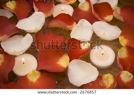 Aromatic candles and colorful rose petals