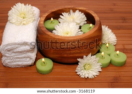 Flowers, candles, and cotton towels in a spa