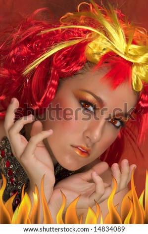 Fire girl with red, orange, yellow hair and beautiful make up