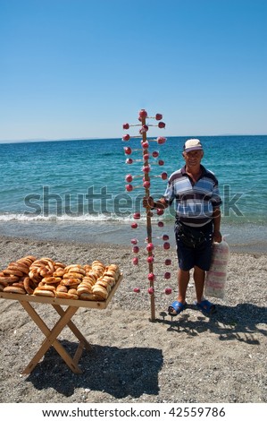 Candied apple salesman selling his apples at the beach