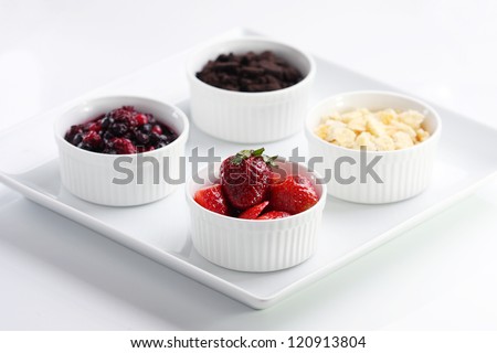 A dish of graham cracker, mixed berries, Oreo, Strawberry