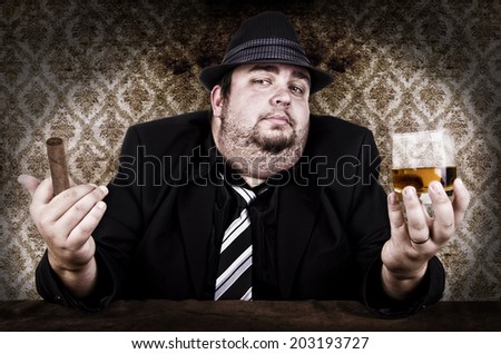 Businessman with a glass of drink and his cigar.