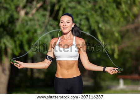 Sport, activity. Cute woman with skipping rope