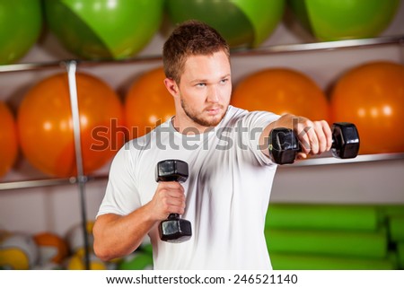 Dumbbell men at gym workout biceps fitness weightlifting