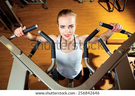 Woman working out in gym - pull ups.